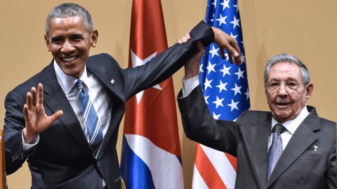 Cuban President Raul Castro tries to lift up Obama's arm at the end of a joint news conference in Havana, Cuba, in March 2016. Castro hailed Obama's opposition to a long-standing economic "blockade," but said it would need to end before ties between the two countries are fully normalized.