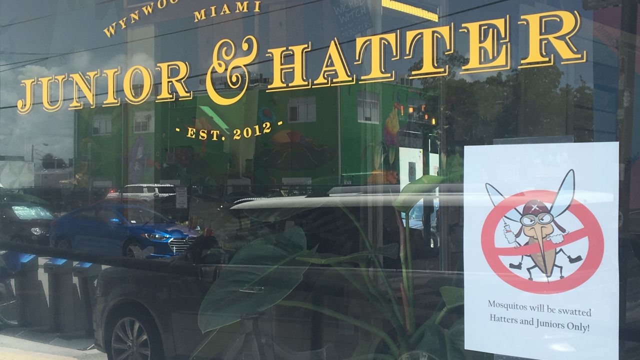 Jill Palma says people in Miami's Wynwood district aren't taking warnings about Zika too seriously. A cartoon banning mosquitoes is now taped to the window of the salon she manages.