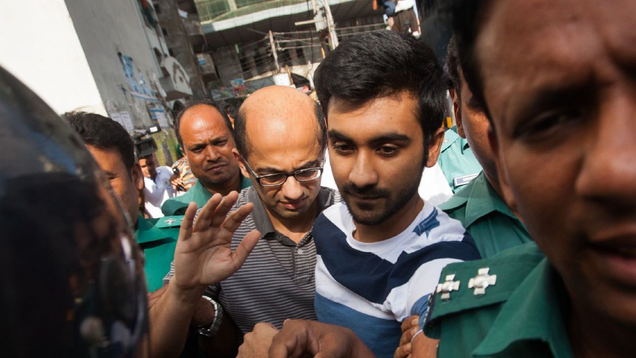 Bangladesh police escort Hasnat Karim (center-left) and Tahmid Hasib (center-right) toward court on August 4, 2016. 