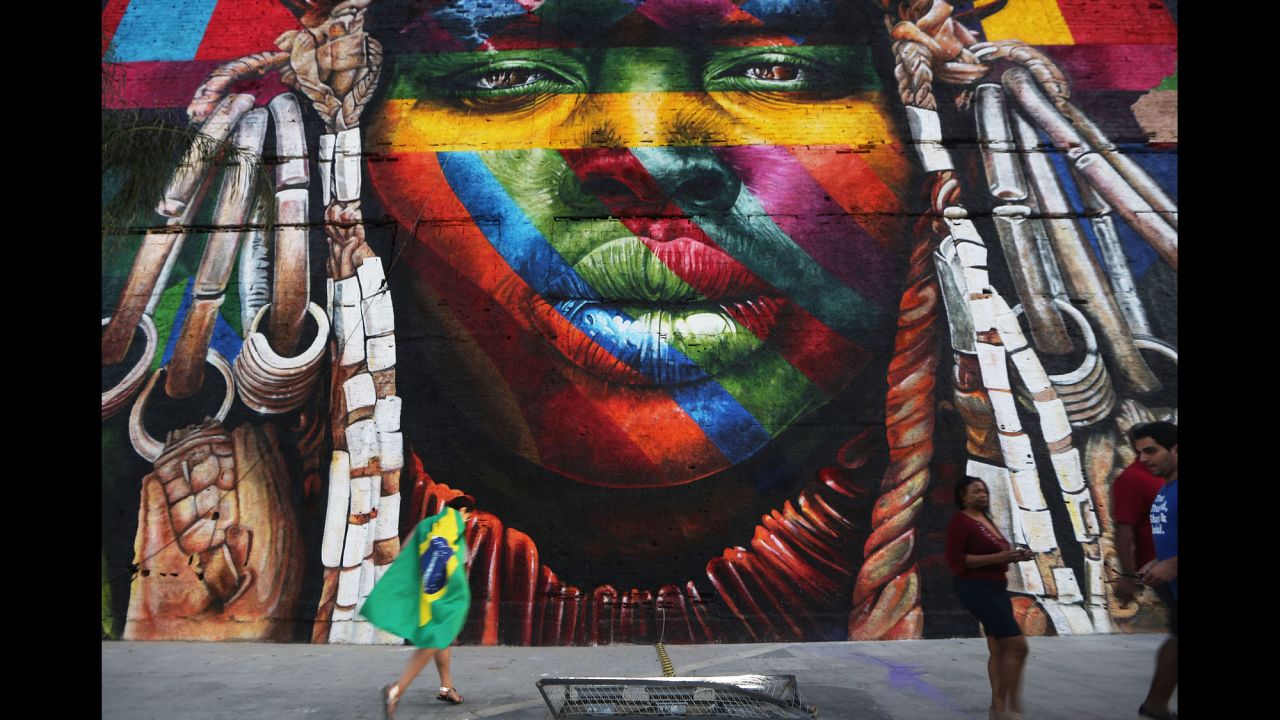 A mural depicts an indigenous face created by Brazilian graffiti artist Eduardo Kobra and assistants on August 4. The 32,000-square-foot "We Are All One" celebrates cultural diversity.