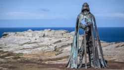 TINTAGEL, UNITED KINGDOM - APRIL 28:  The new 'Gallos' sculpture that has been erected at Tintagel Castle is seen in Tintagel on April 28, 2016 in Cornwall, England. The English Heritage managed site and the nearby town have long been associated with the legend of King Arthur and continue to attract large visitor numbers. However, efforts by English Heritage to update the visitor experience with the Gallos sculpture, along with a rock carving of Merlin's face, which English Heritage say are inspired by the legend of King Arthur and Tintagel Castles royal past, have met with criticism from some Cornish nationalists and historians. (Photo by Matt Cardy/Getty Images)