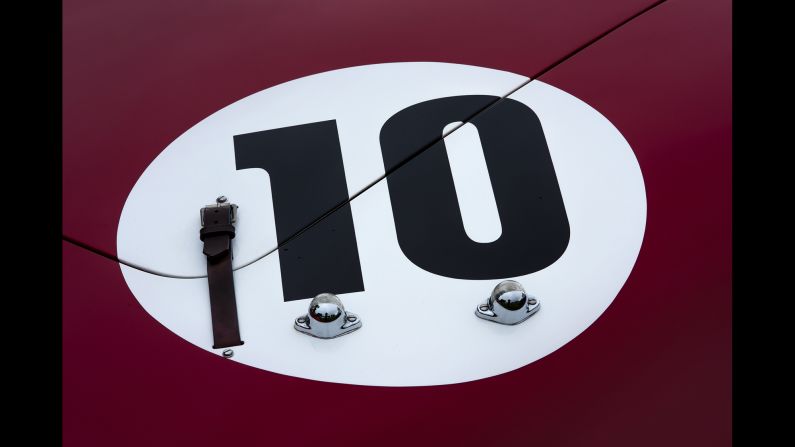 The rear trunk of a 1961 Ferrari 250 Tri/61 Spyder. It has a leather hood clasp and lights to illuminate the No. 10.