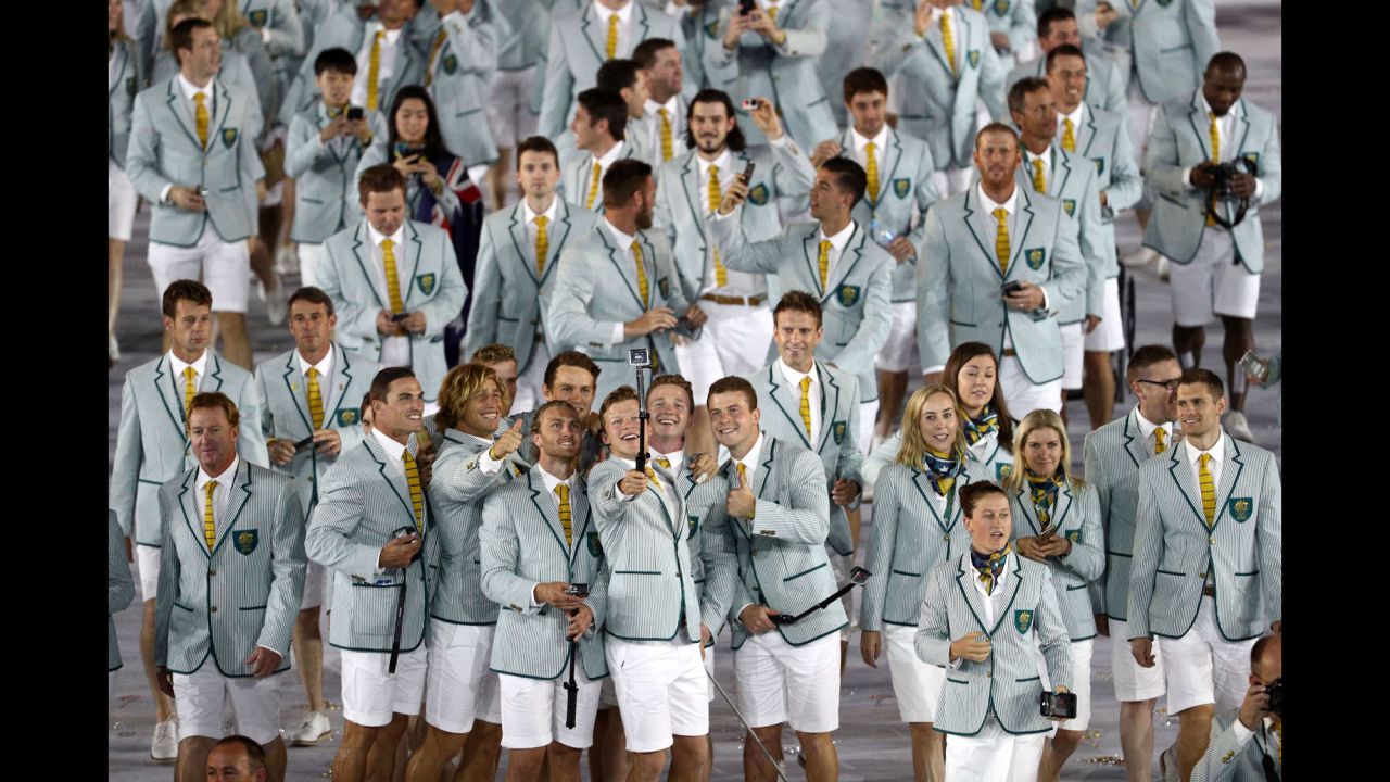 Members of Australia's Olympic team take photos inside the stadium.