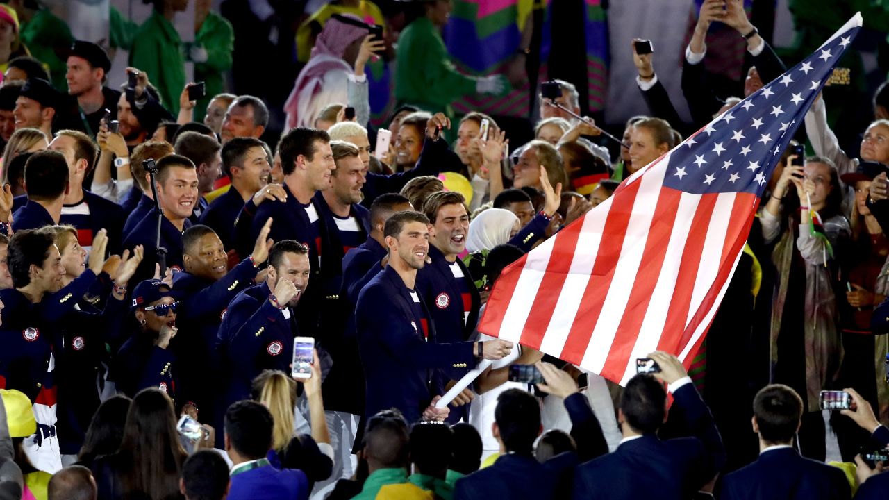 U.S. swimmer Michael Phelps, the most decorated Olympian of all time, carries the American flag into the Maracana Stadium.