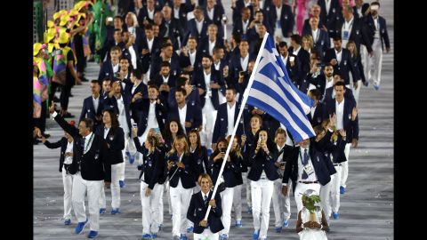 Sailing athlete Sofia Bekatorou leads Greece out.