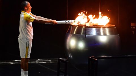 Vanderlei Cordeiro de Lima, a former Brazilian long-distance runner, lights the Olympic cauldron. De Lima was leading the Olympic marathon in 2004 when he was attacked by a protester near the end of the race. He ended up finishing third, but the graceful way he handled the disappointment won him plaudits around the world for his sportsmanship.