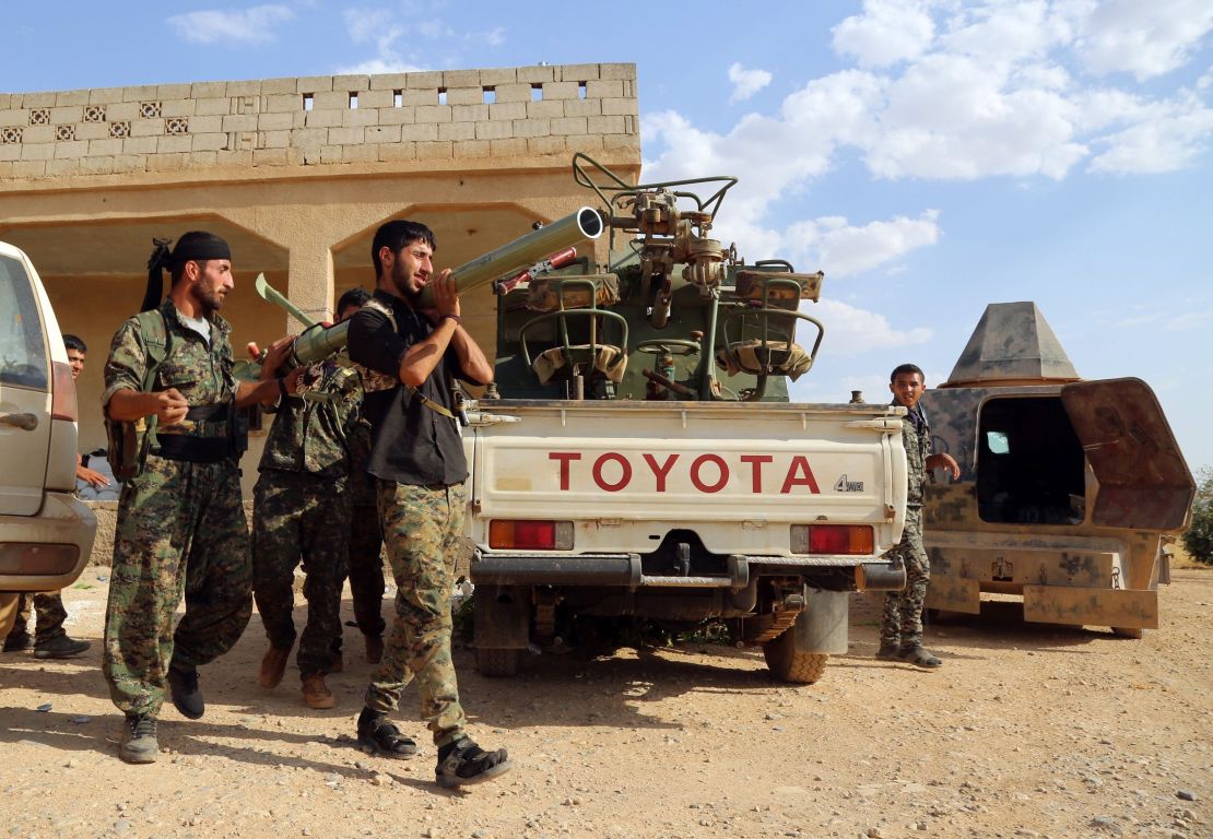 U.S.-backed Kurdish and Arab fighters prepare a rocket-launcher as they advance into Manbij last June.