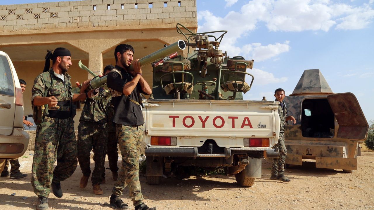 U.S.-backed Kurdish and Arab fighters prepare a rocket-launcher as they advance into Manbij last June.
