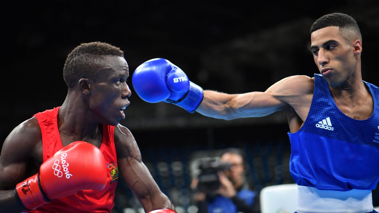 Great Britain's Galal Yafai, right, punches Cameroon's Fotsala Simplice during the men's light fly match.