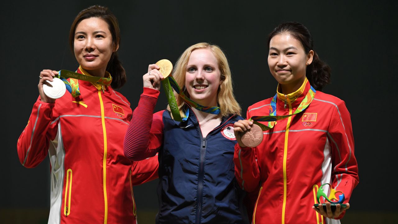 Gold medalist Virginia Thrasher of the U.S., center, poses with China's silver medal winner Du Li, left, and China's bronze medalist Yi Siling during the medal ceremony for the women's 10-meter air rifle shooting event. Thrasher was the first to take home Olympic gold at the Summer Games.