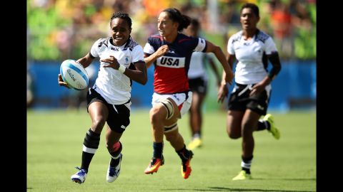 Timaima Ravisa of Fiji runs with the ball to score a try during the women's Pool A rugby match against the United States.