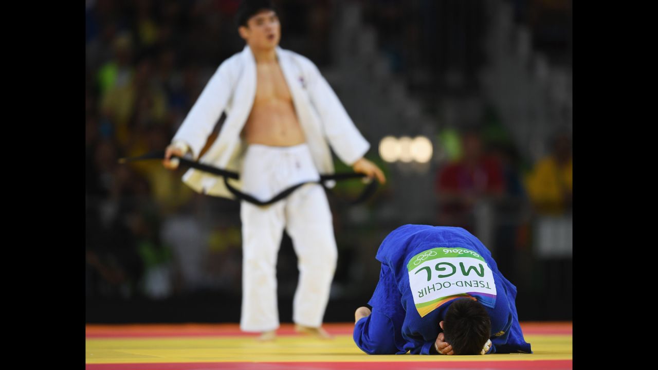 Tsogtbaatar Tsend-Ochir of Mongolia, right, reacts after being defeated by Kim Won-Jin of Republic of Korea in the men's 60kg judo.