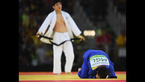 Tsogtbaatar Tsend-Ochir of Mongolia, right, reacts after being defeated by Kim Won-Jin of Republic of Korea in the men's 60kg judo.