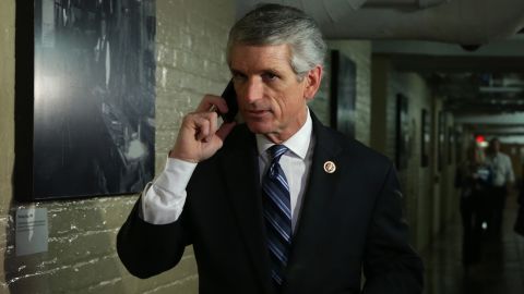 Rep. Scott Rigell (R-VA) talks on his phone as he arrives at a House Republican Conference meeting September 28, 2013 on Capitol Hill in Washington, DC.