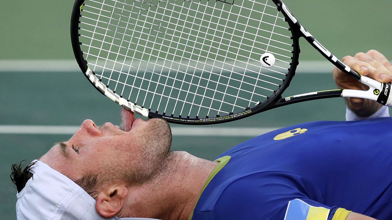 Illya Marchenko, of Ukraine, licks his racquet after losing the match in a tie-breaker during the third set against Andreas Seppi, of Italy.