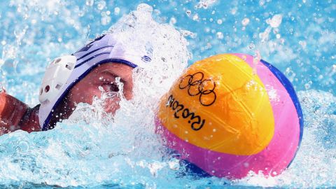 Angelos Vlachopoulos of Greece controls the ball against Japan during the men's water polo preliminary round group A match.