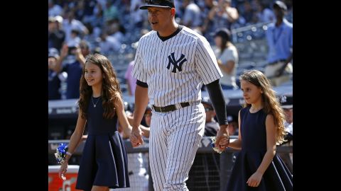 Rodriguez walks onto the field with his daughters, Natasha, left, and Ella, for a pregame ceremony on September 13, 2015 celebrating his 3,000th career hit.