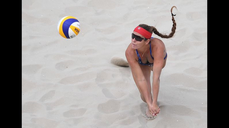 Brooke Sweat of the United States dives for the ball during the women's beach volleyball preliminary round.