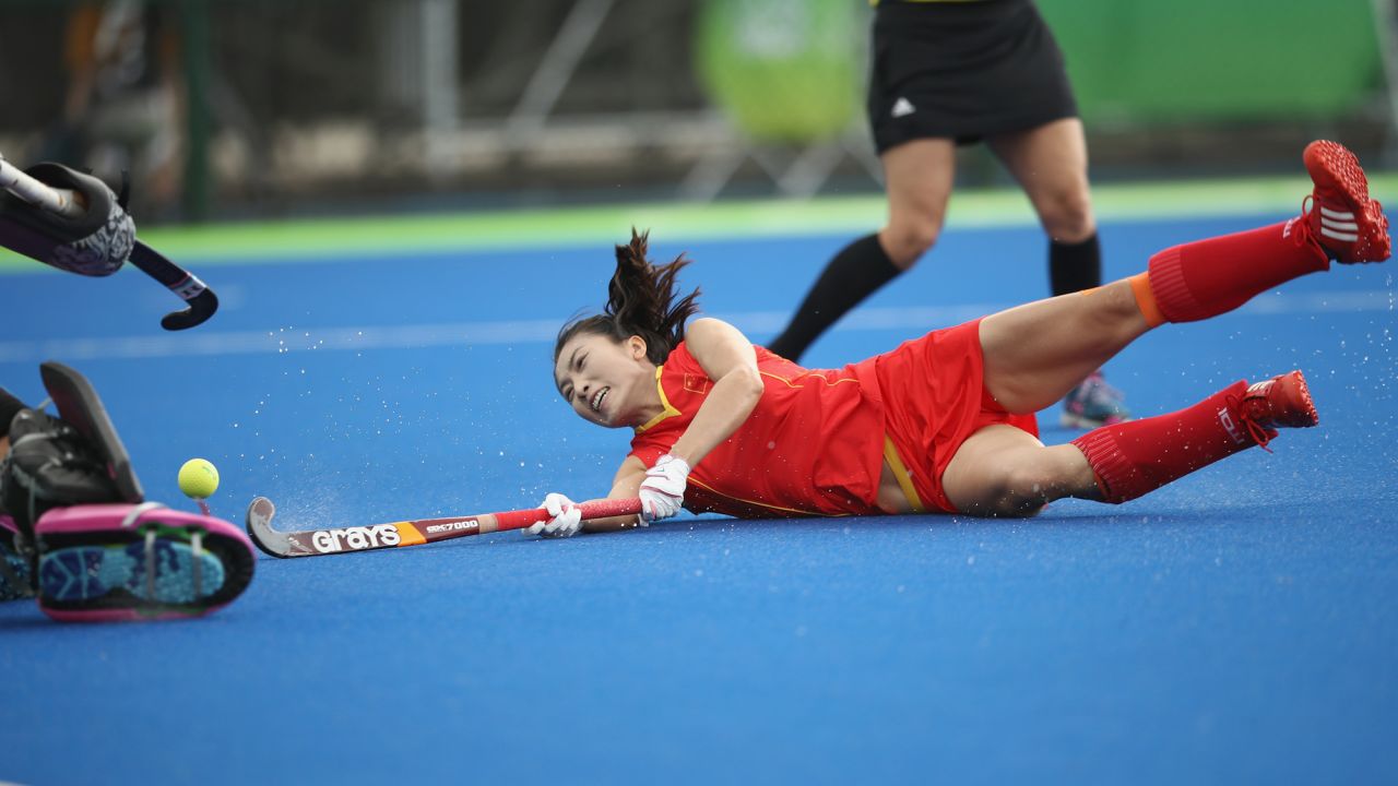 Li Hongxia falls after diving to shoot at goal as China loses 4-1 in its women's field hockey match against Germany.