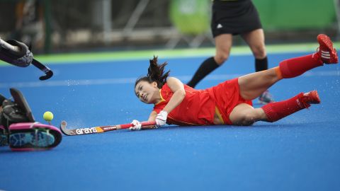 Li Hongxia falls after diving to shoot at goal as China loses 4-1 in its women's field hockey match against Germany.