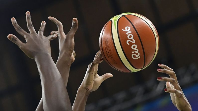Players reach out to the ball during the women's basketball match between USA and Senegal. The Americans won 121-56, <a href="index.php?page=&url=http%3A%2F%2Fedition.cnn.com%2F2016%2F08%2F02%2Fsport%2Fteam-usa-womens-basketball-rio-2016%2Findex.html" target="_blank">setting a new record </a>for the most points scored in Olympic history.