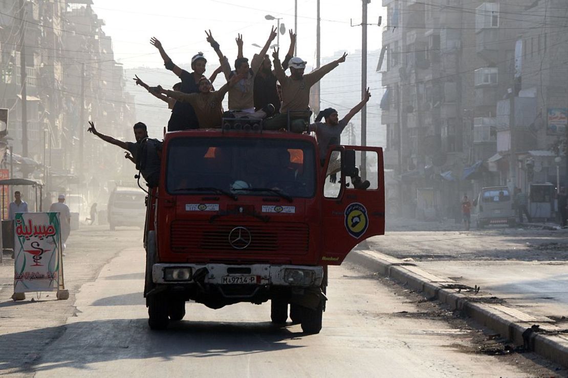 Syrian civil defense volunteers celebrate the breaking of the Aleppo siege.