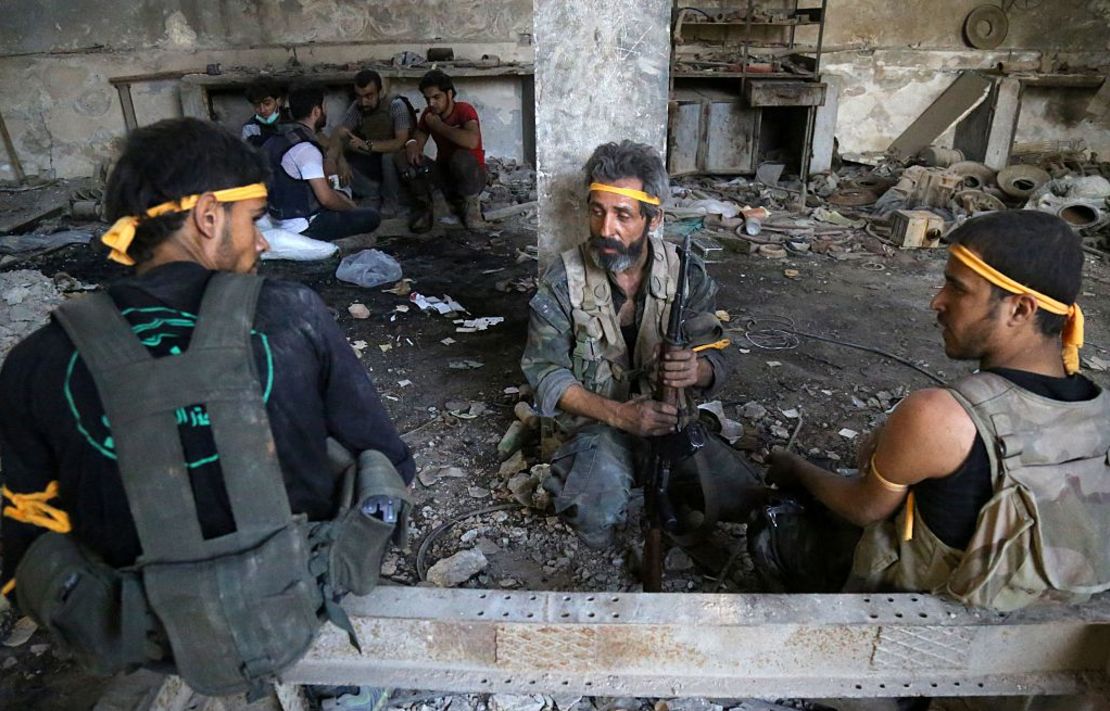 Rebel fighters rest during clashes with regime forces in Al Ramouseh on Aleppo's southwestern fringe Saturday.