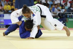 Kosovo's Majlinda Kelmendi (white) competes with Mauritius' Christianne Legentil in quarterfinal match. 