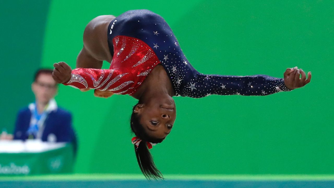 American gymnast Simone Biles leads the field in the women's individual all-around competition at the end of the second day of the Olympics. 