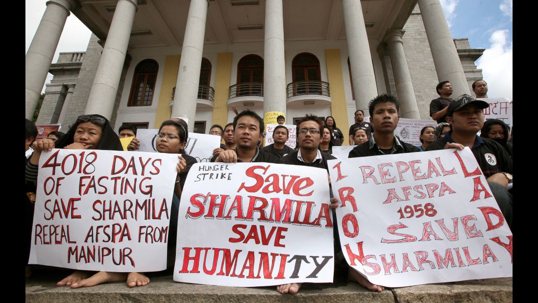 Members of the Bangalore chapter of Manipuri Metei Association hold placards during a silent sit-in protest in support of Irom Sharmila. To prevent her death, Indian authorities force-fed the activist through a plastic drip.