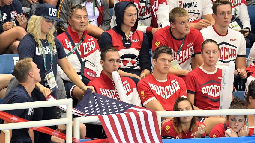 Russia supporters look on as a US team member drapes a US flag during the swimming competitions at the 2016 Summer Olympics, Sunday, Aug. 7, 2016, in Rio de Janeiro, Brazil. (AP Photo/Martin Meissner)