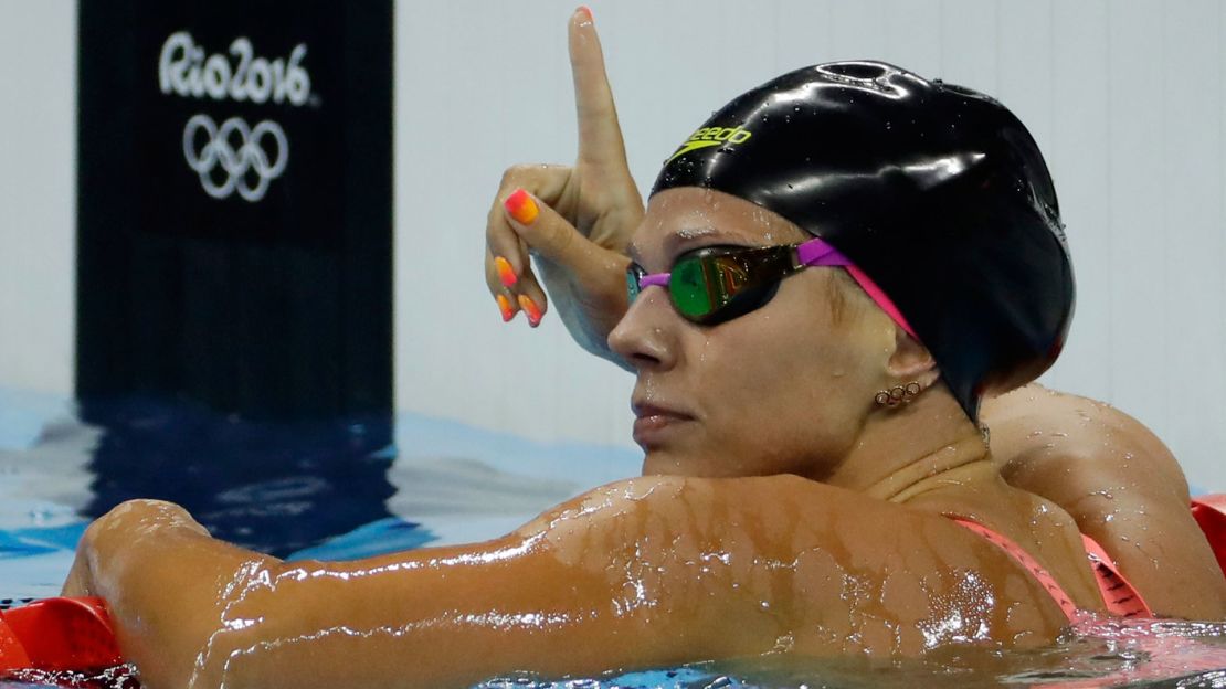 Yulia Efimova celebrates winning her heat in the women's 100-meter breaststroke, much to American Lilly King's chagrin.