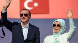Erdogan (L) an his wife Emine Erdogan (R) wave at supporters at the rally.