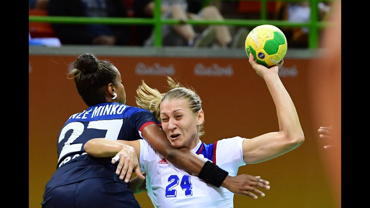 France's Estelle Nze-Minko, left, competes against Russia's Irina Bliznova during a preliminary handball match.