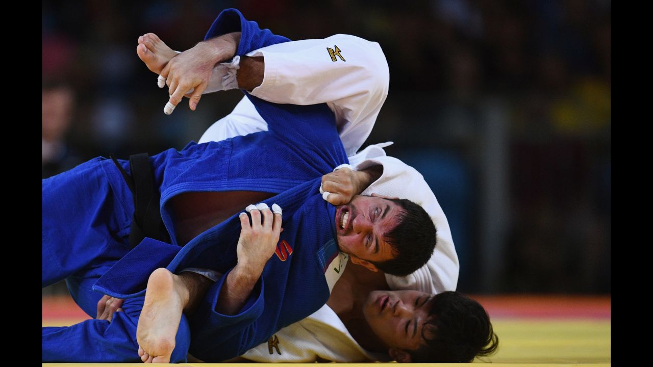 Japanese judoka Shohei Ono, in white,  competes against Victor Scvortov of the United Arab Emirates. Ono went on to win gold in the 73-kilogram weight class.