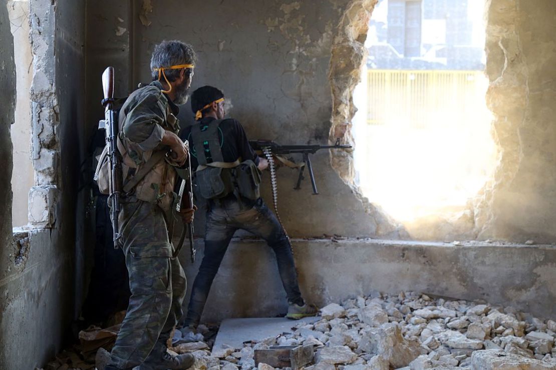 Rebel fighters fire at government positions in Ramouseh, southwest Aleppo Saturday.