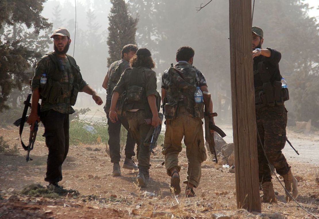 Fighters from Jabhat Fateh al Sham --  formerly the al Nusra Front -- advance through a government military complex in Aleppo Saturday.