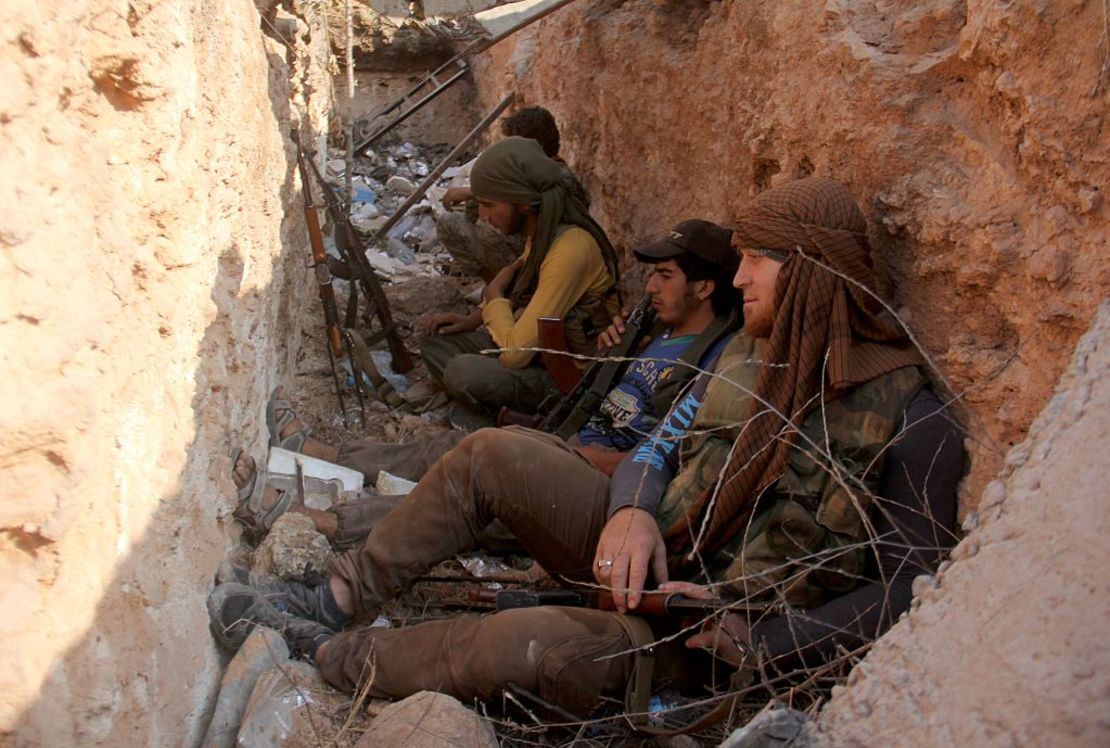 Fighters from Jabhat Fateh al Sham --  formerly the al Nusra Front -- sit in a trench after capturing a key government position in Aleppo.