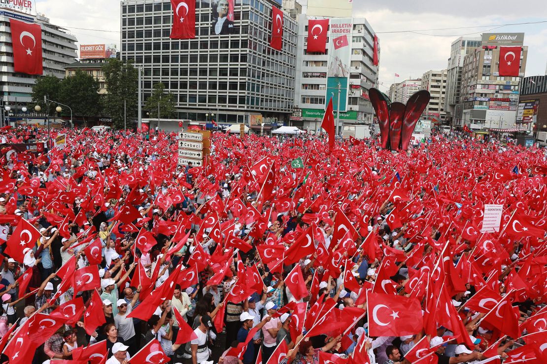 People wave Turkish national flags as they gather in Ankara during a rally against the failed military coup.