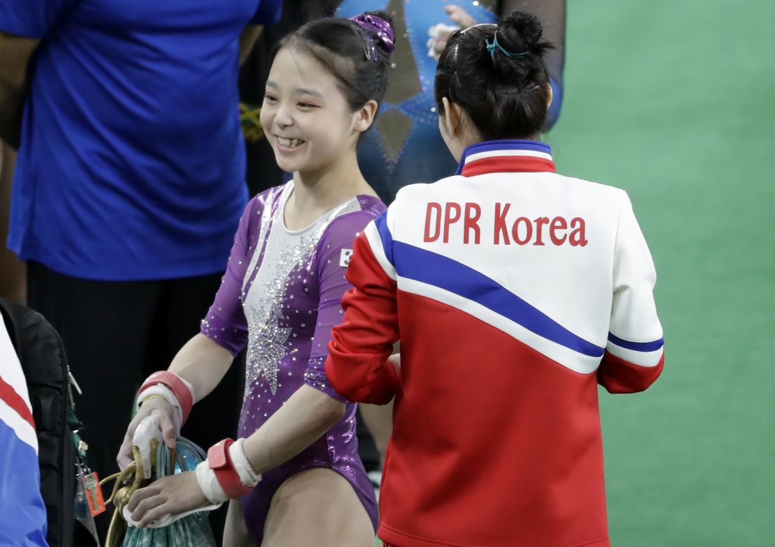 South Korea's Lee Eun-ju, left, smiles as she talks with North Korea's Hong Un Jong during the artistic gymnastics women's qualification.