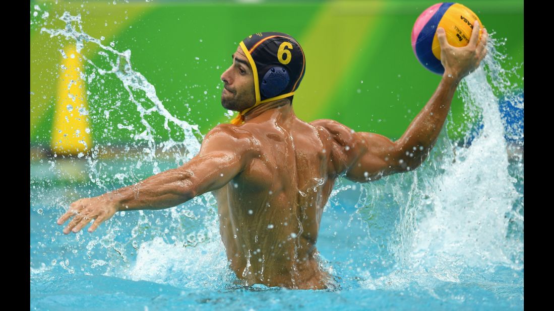 Spanish water polo player Marc Minguell shoots for goal during a 10-9 victory over the United States.