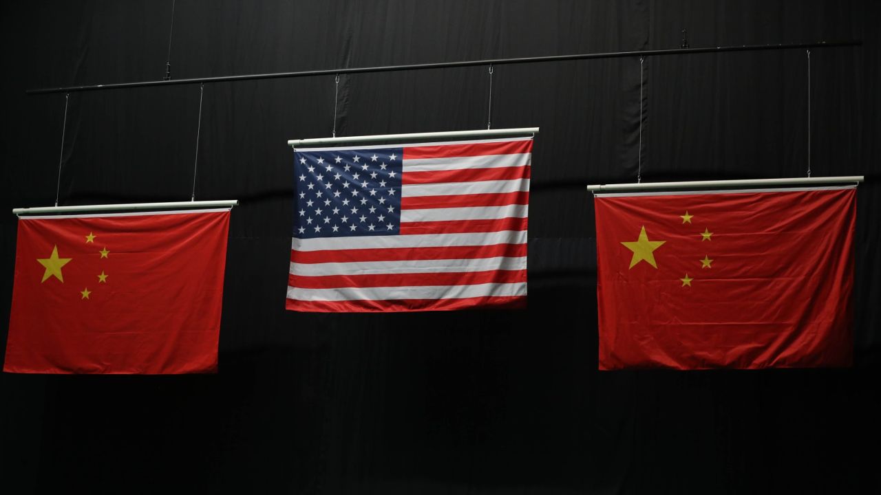 Incorrect Chinese flags are flanked by an American flag during a medal ceremony for the 10m air rifle competition.