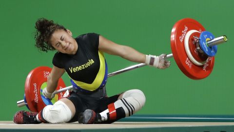 Venezuelan weightlifter Yusleidy Figueroa falls as she competes in the 58-kilogram weight class.
