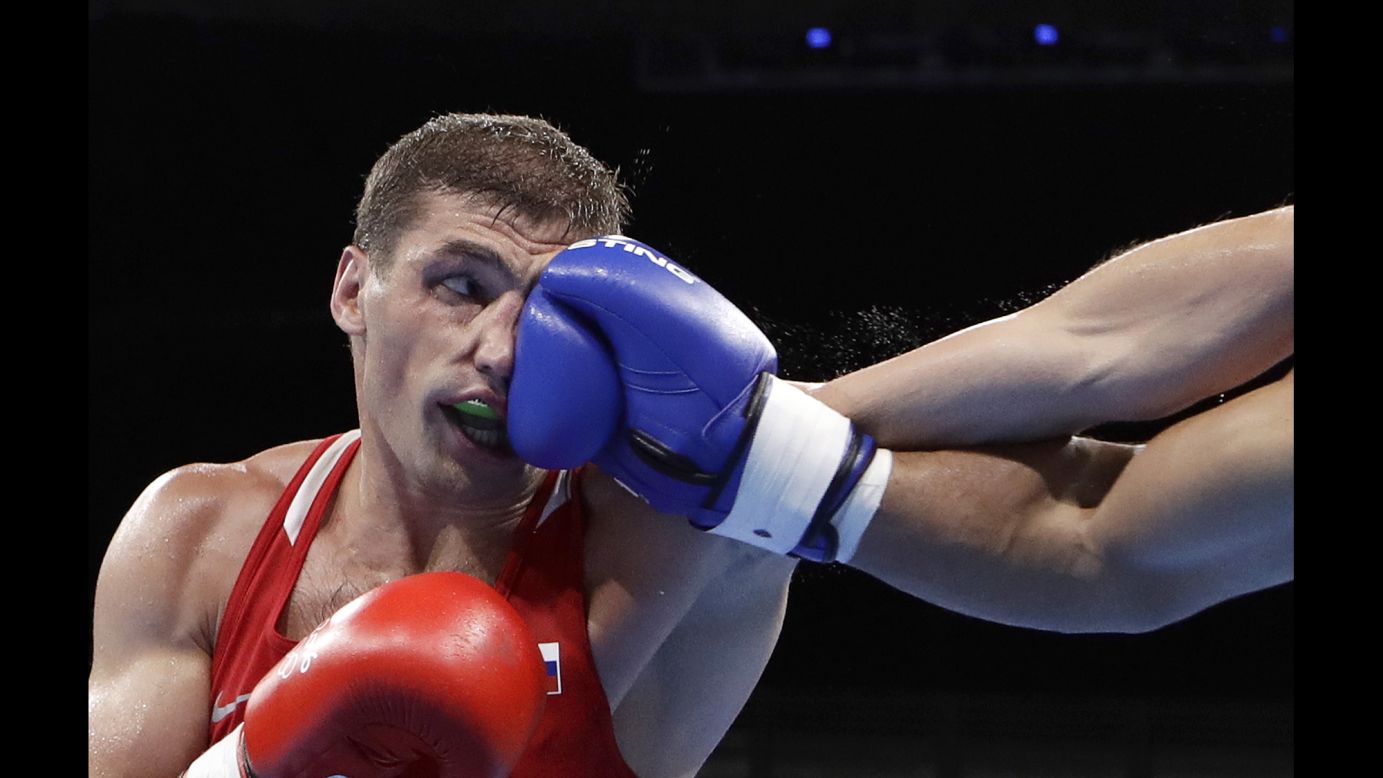 Petr Khamukov, a light-heavyweight boxer from Russia, is punched by Venezuela's Albert Ramirez during a preliminary match on Sunday, August 7. Ramirez won the bout to advance to the round of 16.