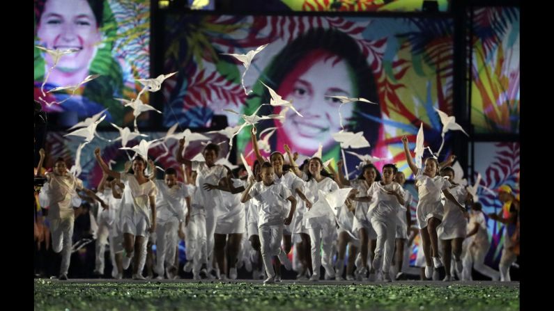 Children fly kites during the opening ceremony on Friday, August 5.