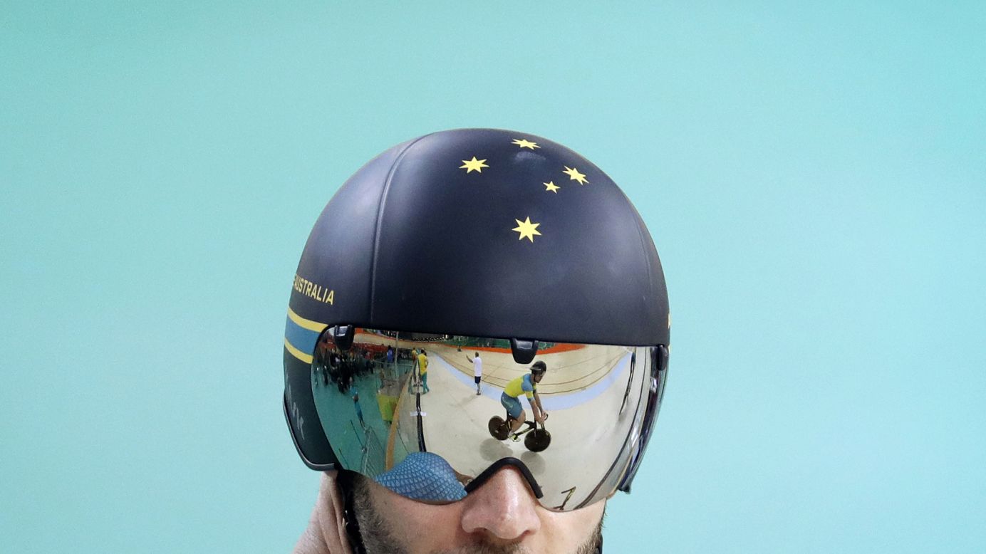 An Australian cyclist is reflected on a teammate's visor during a training session on Thursday, August 4.