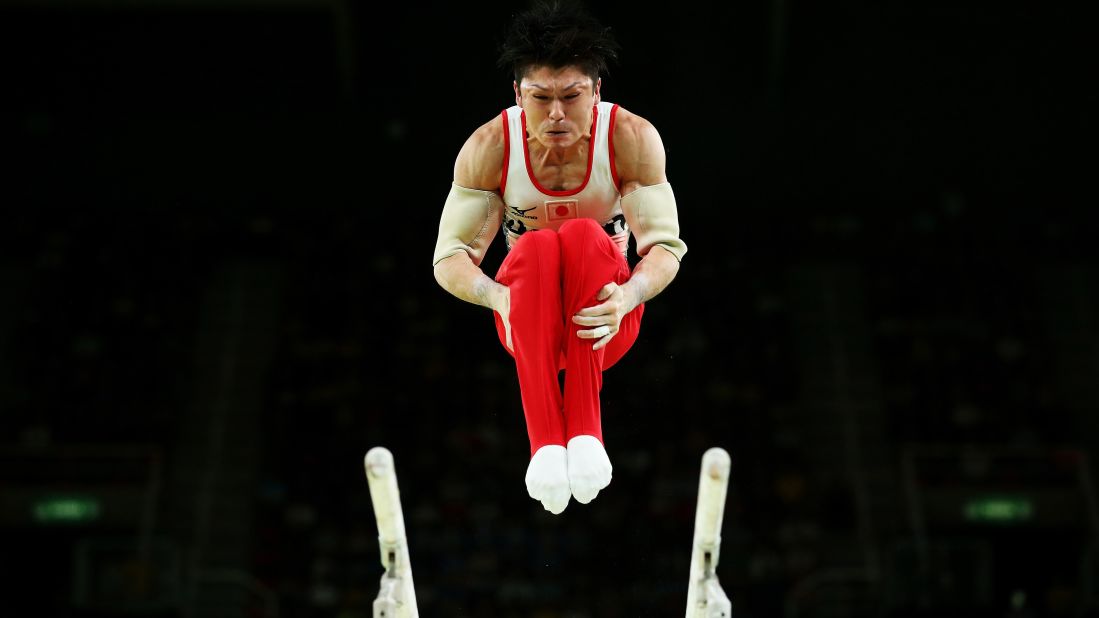 Japanese gymnast Kohei Uchimura -- the reigning Olympic champion -- competes on the parallel bars during the team all-around event. Japan won the gold.