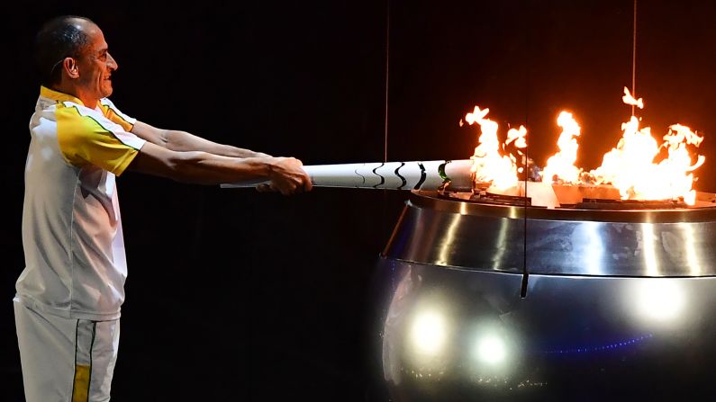 Vanderlei Cordeiro de Lima, a former Brazilian long-distance runner, lights the Olympic cauldron during <a href="index.php?page=&url=http%3A%2F%2Fwww.cnn.com%2F2016%2F08%2F05%2Fsport%2Fgallery%2Folympics-opening-ceremony%2Findex.html" target="_blank">the opening ceremony</a> in Rio de Janeiro on Friday, August 5. De Lima was leading the Olympic marathon in 2004 when he was attacked by a protester near the end of the race. He ended up finishing third, but the graceful way he handled the disappointment won him plaudits around the world for his sportsmanship.