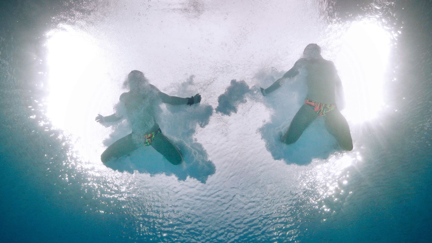 Ukrainian synchronized divers Maksym Dolgov and Oleksandr Gorshkovozov splash in the water as they compete in the 10-meter platform on Monday, August 8.