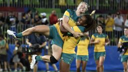 Australia's Ellia Green lifts up a teammate as they celebrate victory in the womens rugby sevens gold medal match with New Zealand.